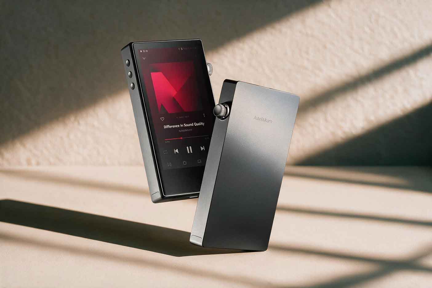 A compact metal-bodied portable digital audio player resting at an angle on a table under soft raking light.