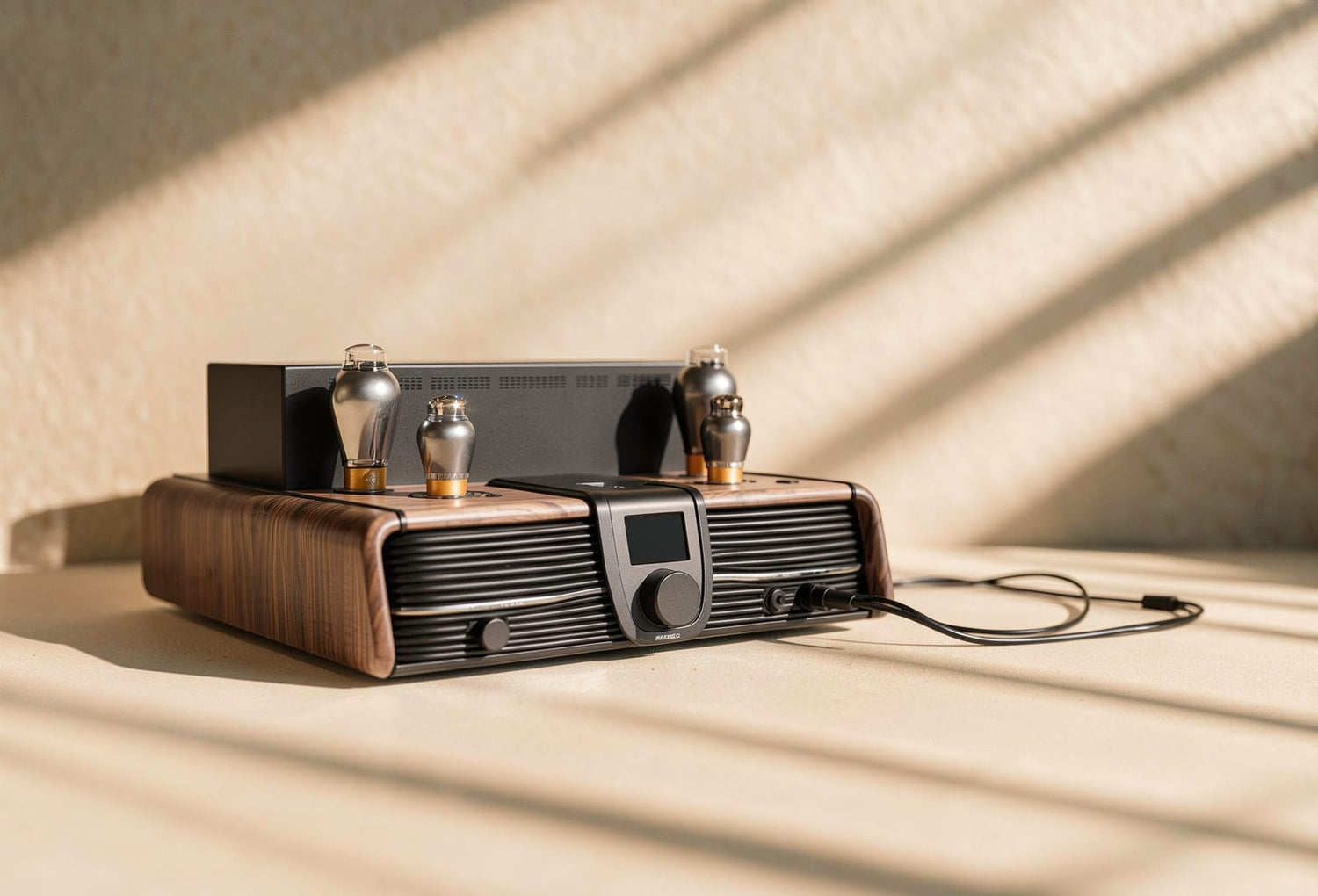 The Feliks Audio Eos: a walnut-wrapped 300B hybrid amplifier with four valves, a central monitoring display and volume control, in raking daylight.