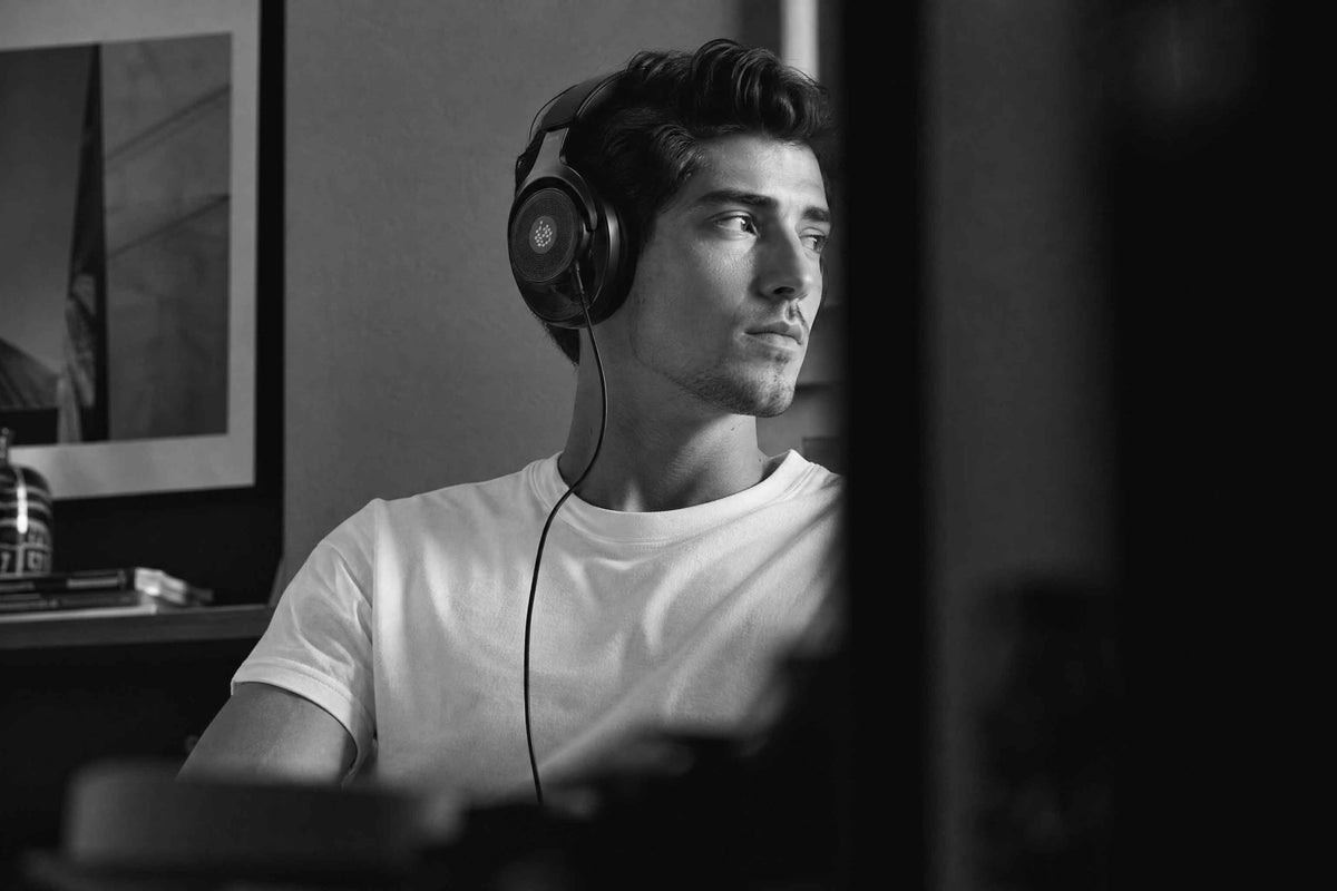 a man listening to Adam L715 headphones